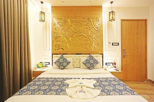 a bedroom with a bed with a towel on it at JRD Luxury-Business Hotel in New Delhi