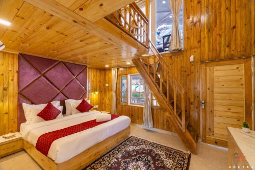 a bedroom with a bed in a room with wooden walls at Zostel Plus Kareri in Dharamshala