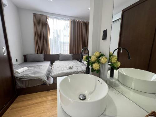 a bathroom with a sink and a bed at Ninh Binh Truong Nhan homestay in Ninh Binh