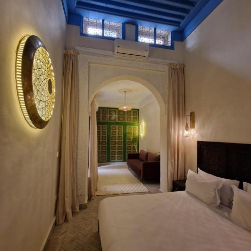 a bedroom with a bed and a living room at Riad Contessa & spa in Marrakesh