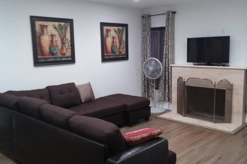a living room with a couch and a fireplace at Family getaway 3 BR 2 Bath home in Lomita, CA. in Los Angeles