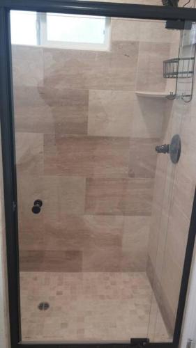 a shower with a glass door in a bathroom at Family getaway 3 BR 2 Bath home in Lomita, CA. in Los Angeles