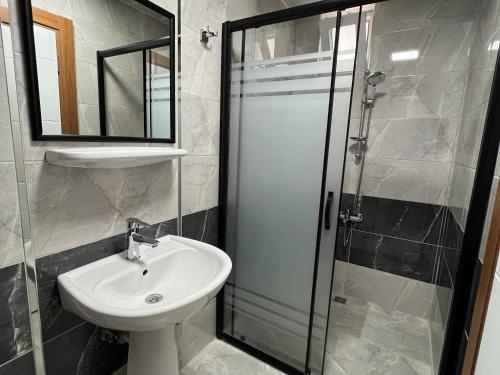 a bathroom with a sink and a shower at Ada APART&HOTEL in Antalya