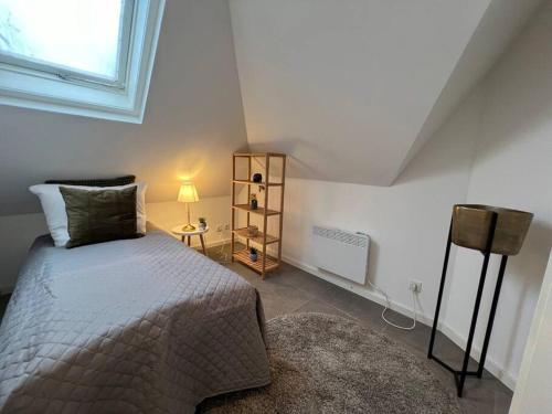 a small bedroom with a bed and a window at Urban Charm Design Loft in Koblenz
