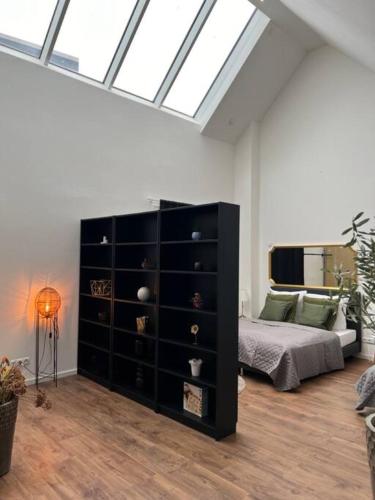 a bedroom with a black dresser and a bed at Urban Charm Design Loft in Koblenz