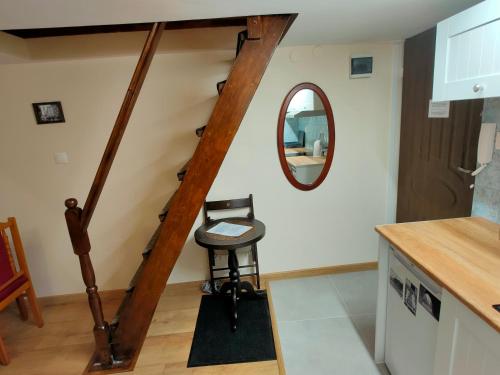 a stairway with a stool and a mirror at Krakow Old Town Apartment in Krakow