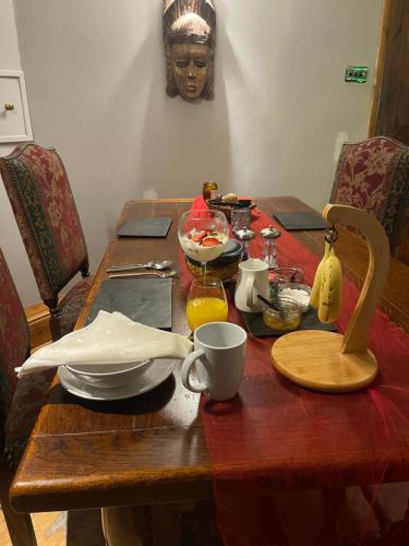 a wooden table with a table cloth on it at South Lodge House in Dormans Land