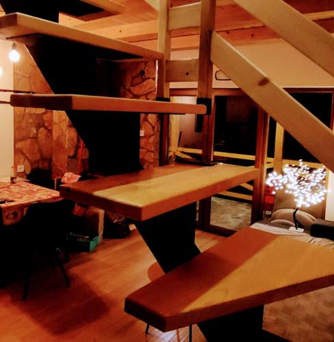 a staircase in a room with a table and benches at Brvnara Tarska Zora in Sekulić 