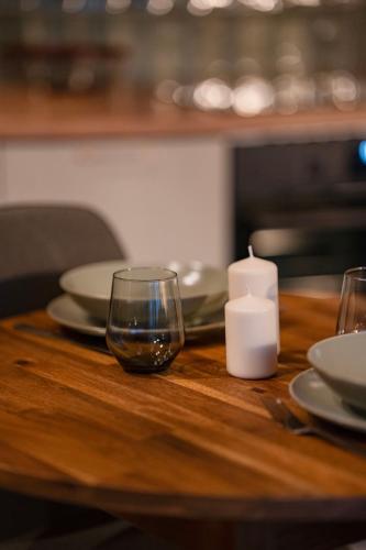 a wooden table with a candle and a glass on it at Daczowisko in Gruczno