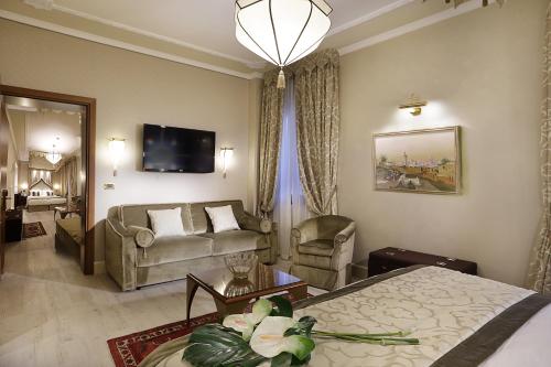 a hotel room with a bed and a couch at Ai Mori d'Oriente in Venice