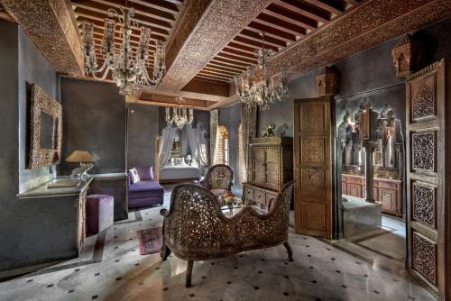 a living room with a couch and a chair at La Sultana Marrakech in Marrakesh