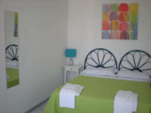 Postel nebo postele na pokoji v ubytování Residenze Azzurra