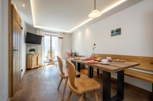 a dining room with a wooden table and chairs at Wimmerhof in Höslwang