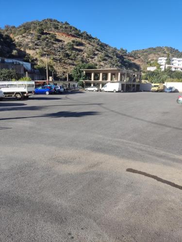 an empty parking lot with a mountain in the background at Kissandros Hotel in Agia Galini