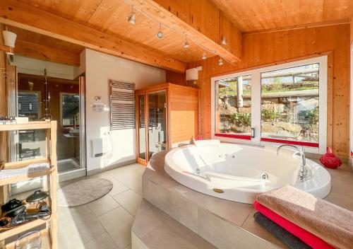 a large bathroom with a large tub in it at 1A Chalet "Wolke" Ski und Wellness im Traumhaus in Wolfsberg