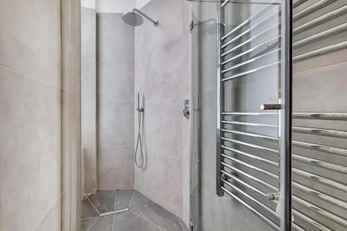 a shower with a glass door in a bathroom at Kensington Studios in London