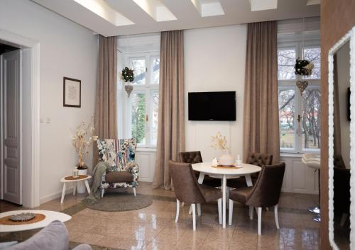 a living room with a table and chairs at Apartment HYGGE in Subotica