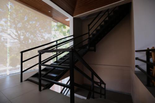 a spiral staircase in a room with a window at Coop Safari Hotel in Tissamaharama