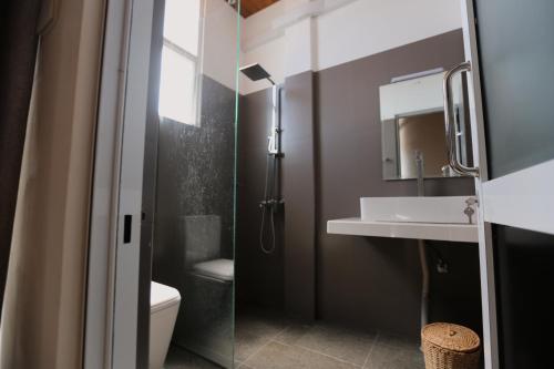 Coop Safari Hotel في تيساماهاراما: حمام مع دش ومغسلة ومرحاض