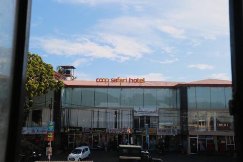 a building with a sign on top of it at Coop Safari Hotel in Tissamaharama