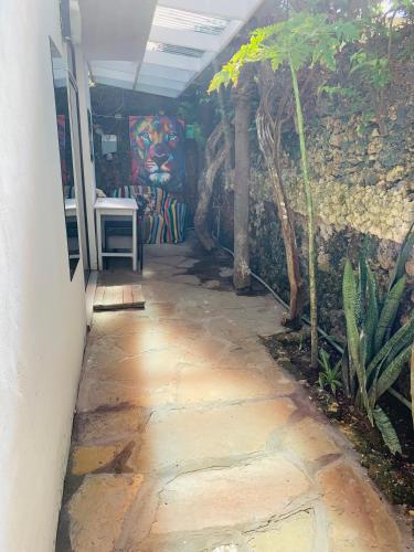 a walkway leading into a room with a wall at Moraa’s Home in Mombasa