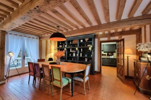 a dining room with a wooden table and chairs at Maddalena - Charming country villa for 10 people in Barneville-la-Bertran