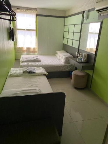Ένα ή περισσότερα κρεβάτια σε δωμάτιο στο Best Hotel