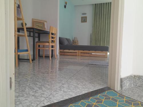 a living room with a couch and a bed at QV Home in Ho Chi Minh City