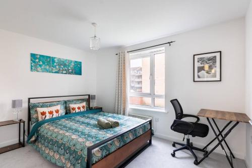 a bedroom with a bed and a desk and a chair at Live the Wembley Buzz! Stylish Flat near Station & Amenities in London