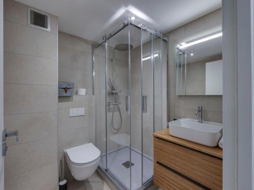a bathroom with a shower and a toilet and a sink at Appartement Tignes, 3 pièces, 6 personnes - FR-1-641-4 in Tignes