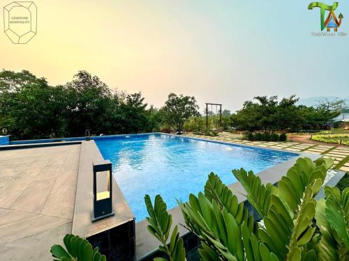 an image of a swimming pool in a villa at Luxurious 3BHK W//Pool Teakwood Villa By Gemstone Hospitality in Alibag