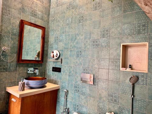 a bathroom with a sink and a mirror at Luxurious 3BHK W//Pool Teakwood Villa By Gemstone Hospitality in Alibag