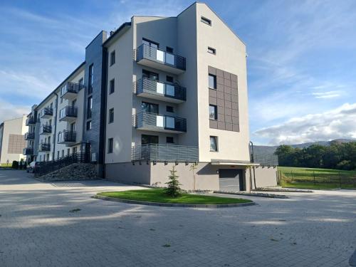 a large apartment building in a parking lot at Marco Polo in Jaworze