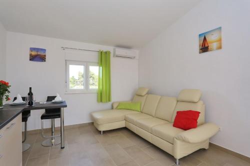 a living room with a couch and a desk at Apartments Jadro in Vir