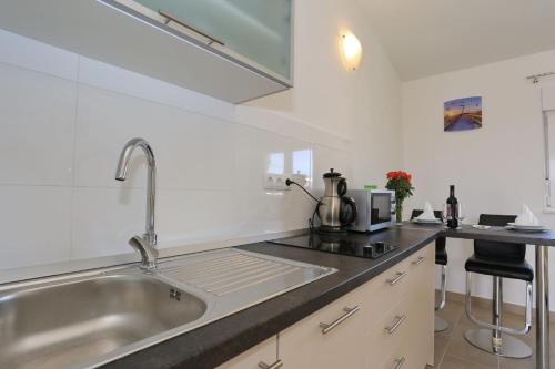 a kitchen with a sink and a counter at Apartments Jadro in Vir