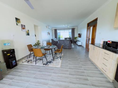 a living room with a table and chairs at Semo's Siloam apartments in Mombasa