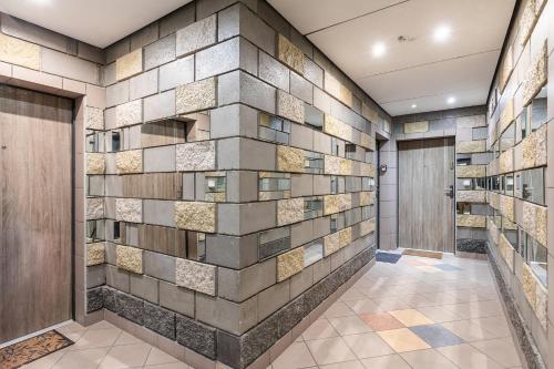 a lobby with a wall of tiles at SuperApart J. Chrościckiego 87 in Warsaw