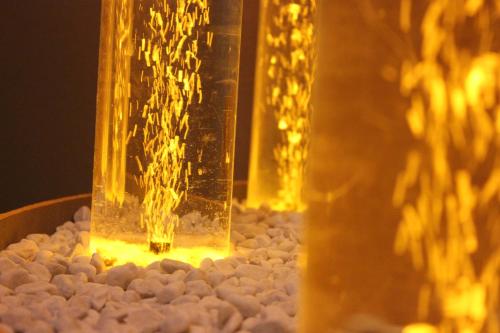 a glass jar filled with water sitting on rocks at Cabo Nonsmoking-Hotel  in Hamburg