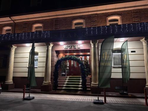 a hotel with a wreath on the front of it at HL 309 Hotel in Tashkent