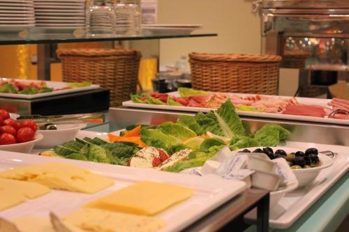 a buffet line with many different types of food at Cabo Nonsmoking-Hotel  in Hamburg