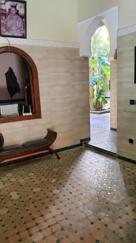 a room with a bench in a room with a window at Riad Tidar by Phoenix in Marrakesh