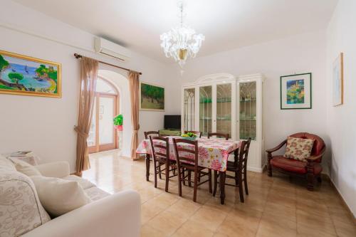 a living room with a dining room table and chairs at Casa Danira - Positano in Positano