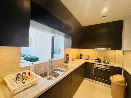 a kitchen with a sink and a counter top at 2BR,Direct to Dubai mall, Burj Khalifa52 in Dubai