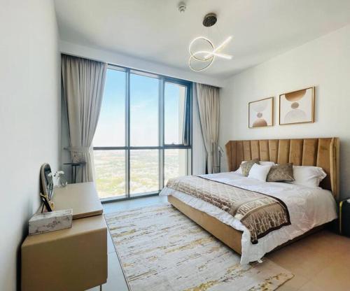 a bedroom with a bed and a large window at 2BR,Direct to Dubai mall, Burj Khalifa52 in Dubai