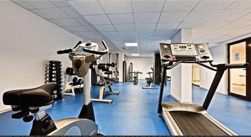 a gym with several tread machines and a treadmill at Апартамент Belvedere Е301 in Bansko