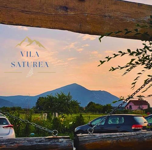 a view of two cars parked in front of a mountain at Villa Saturea in Boljevac