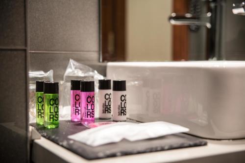 a bathroom counter with four different colored bottles on it at Tinas de Pechon in Pechón