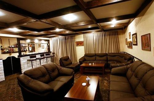 a living room with couches and a coffee table at Hotel Abu in Gudauri