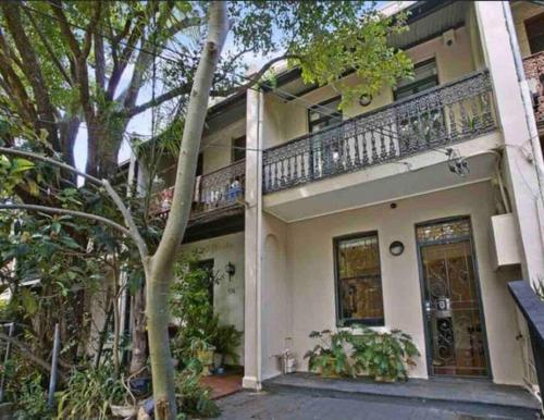 a large white house with a balcony on it at Immaculate 3 Bed City Home - Close to Everything! in Sydney