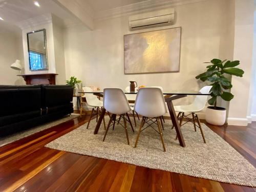 a living room with a dining room table and chairs at Immaculate 3 Bed City Home - Close to Everything! in Sydney